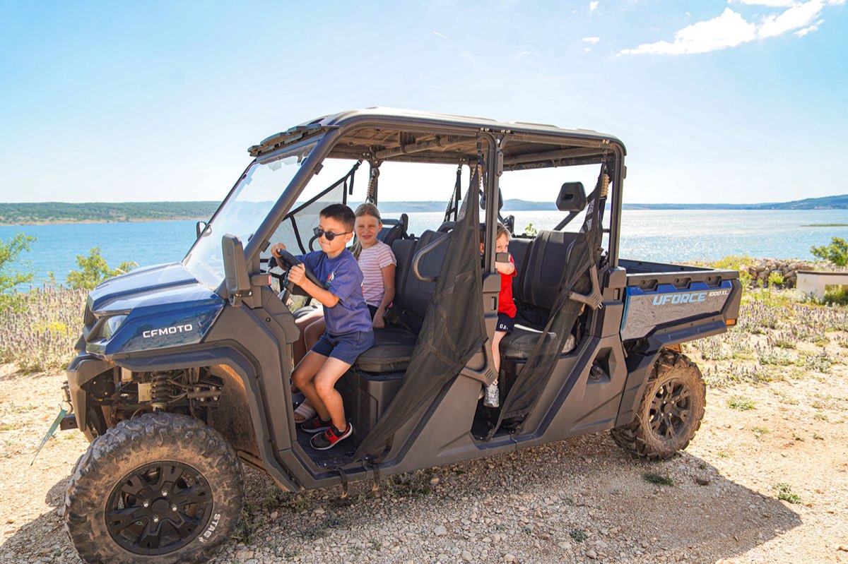 Family riding a guided buggy tour through Velebit mountain